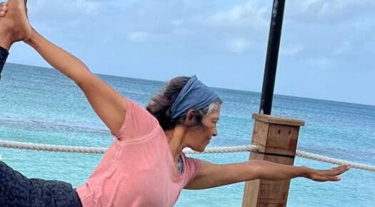 Person practicing yoga by the sea at Breathe with Betty, Grand Cayman, KY, enhancing wellness and serenity.