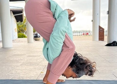 Woman practicing yoga at Breathe with Betty, Grand Cayman, KY, showcasing flexibility and focus.