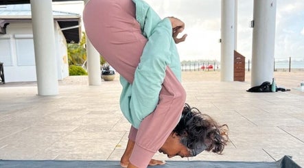 Woman practicing yoga at Breathe with Betty, Grand Cayman, KY, showcasing flexibility and focus.