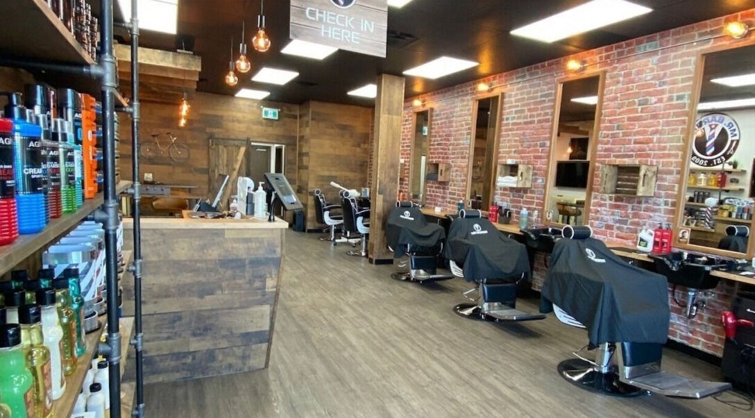 Interior of Mr. Barber Chappelle - Windermere in Edmonton, Alberta, CA with chairs and styling products.