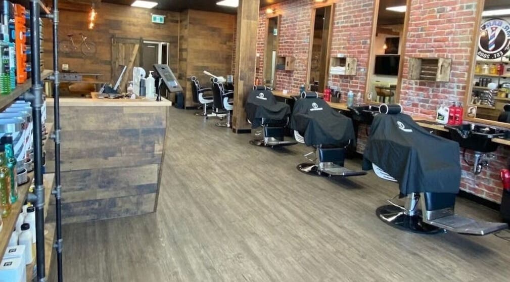 Interior of Mr. Barber Leduc in Leduc, Alberta, CA showcasing rustic barber chairs and modern decor.