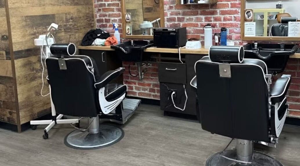 Interior of Mr. Barber St. Albert in St. Albert, Alberta, CA, featuring sleek black barber chairs and mirrors.