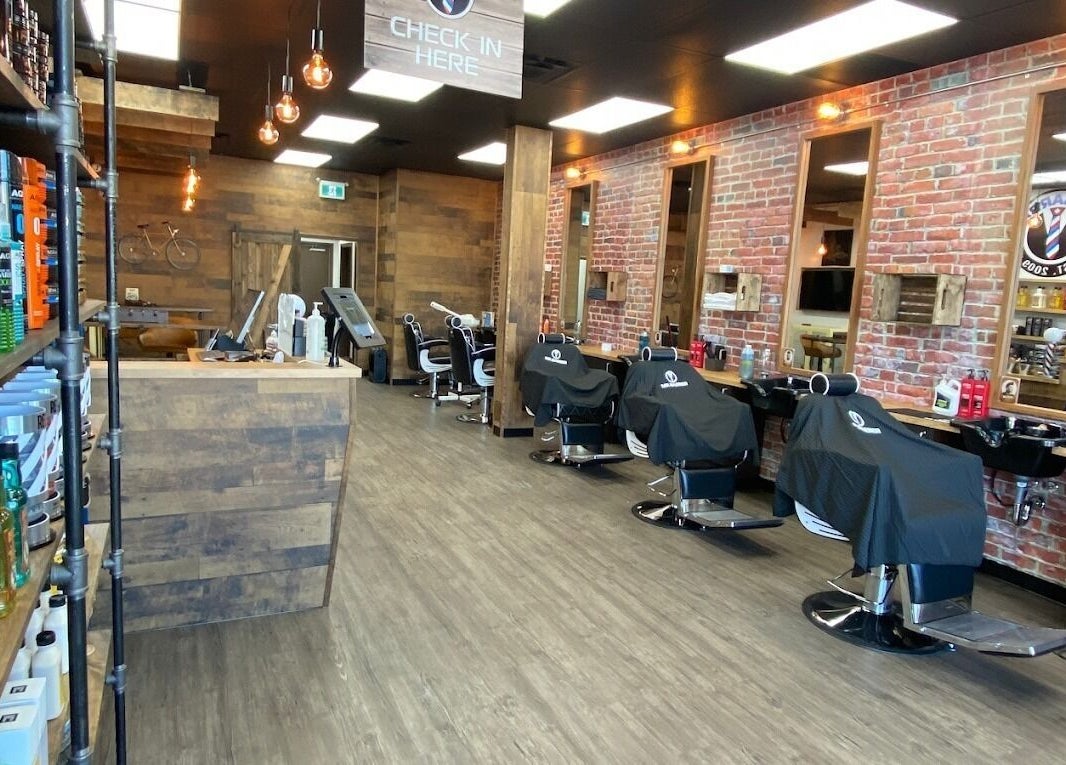 Interior of Mr. Barber Tamarack in Edmonton, Alberta, CA featuring sleek chairs and stylish decor.