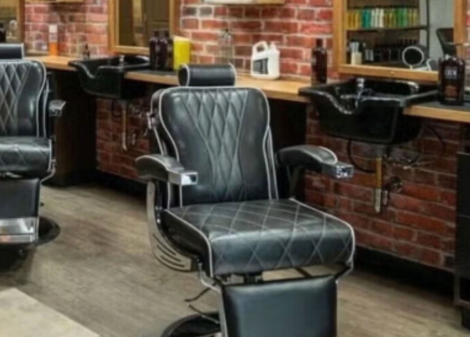 Luxury barber chair at Mr. Barber Tamarack in Edmonton, Alberta, CA showcasing stylish interior design.