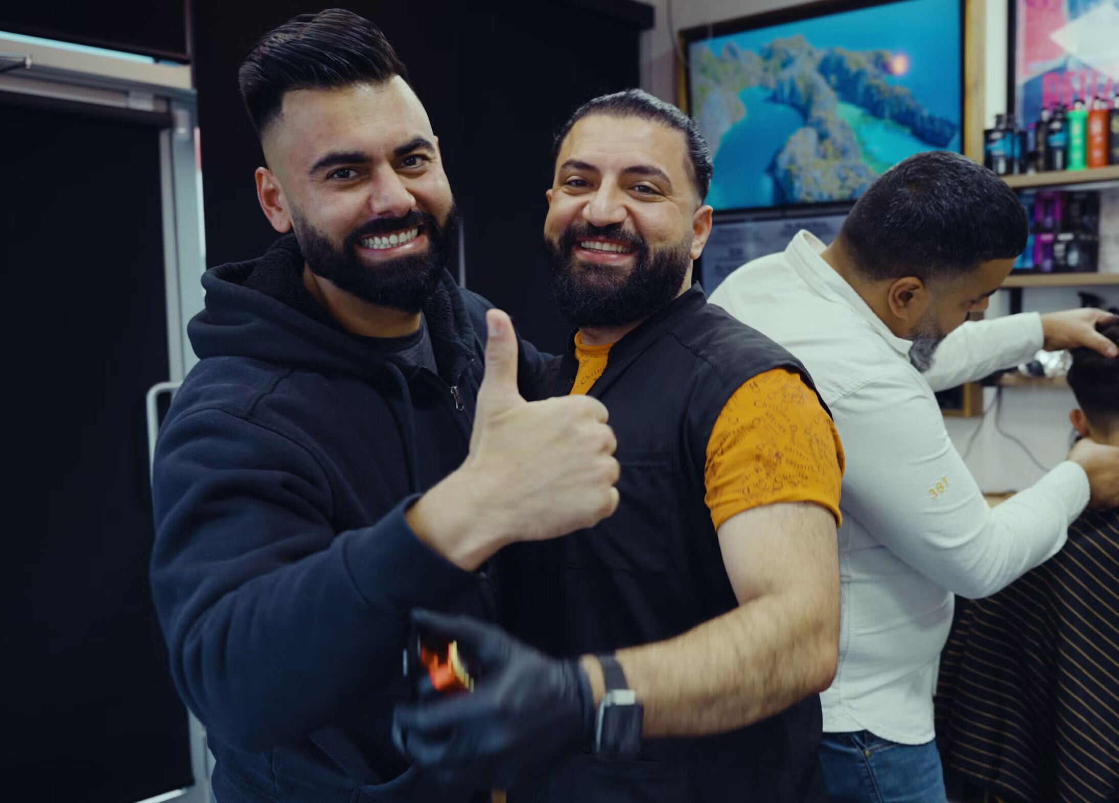 Staff and client smiling at Mr. Barber Tamarack, Edmonton, Alberta, CA, showcasing a welcoming atmosphere.