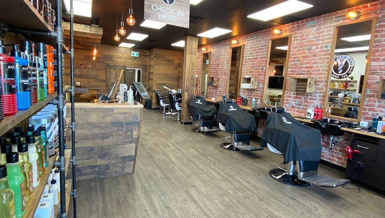 Chic interior of Mr. Barber Unity Square, Edmonton, Alberta, CA with lined barber chairs and products.