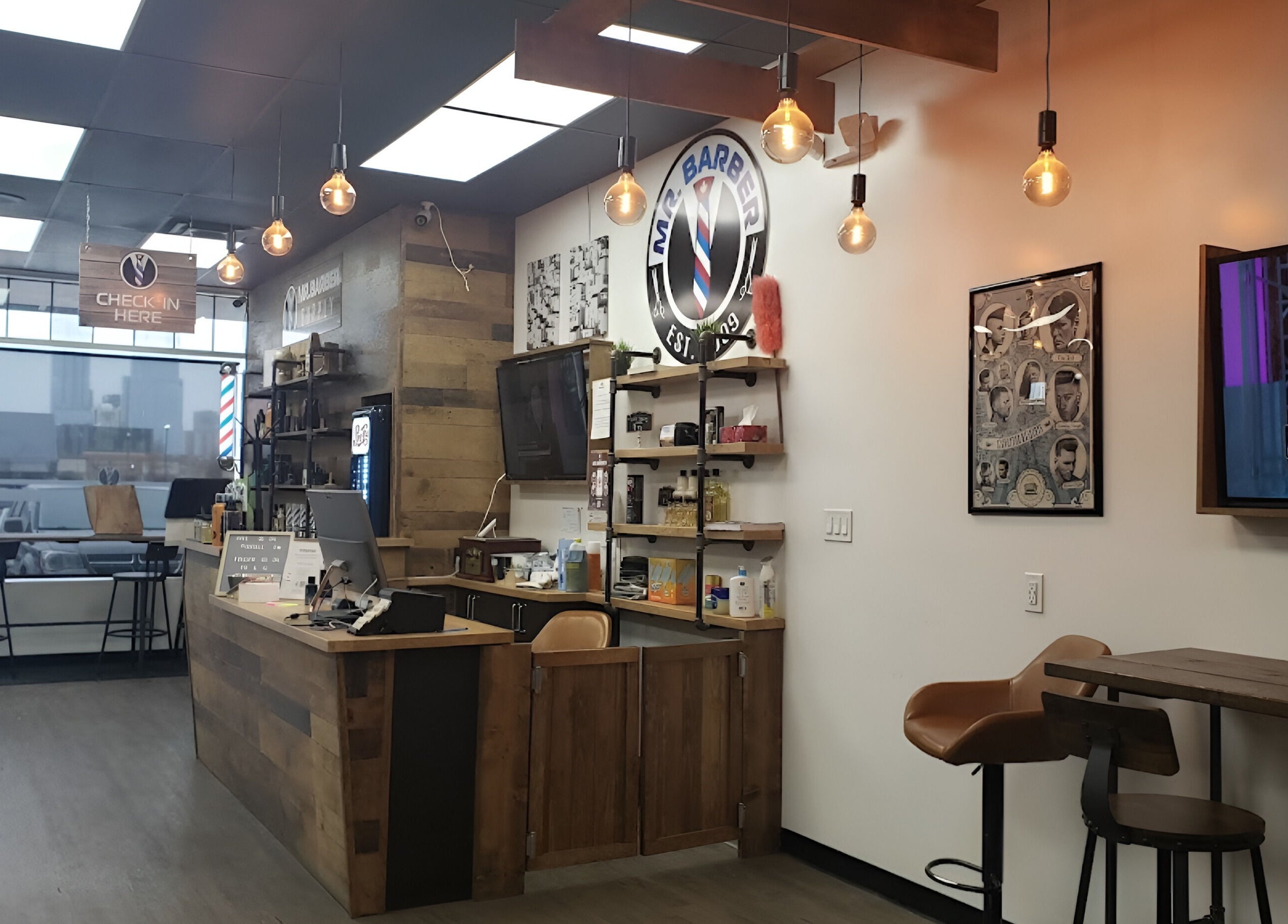 Interior of Mr. Barber Unity Square in Edmonton, Alberta, CA with modern decor and seating area.