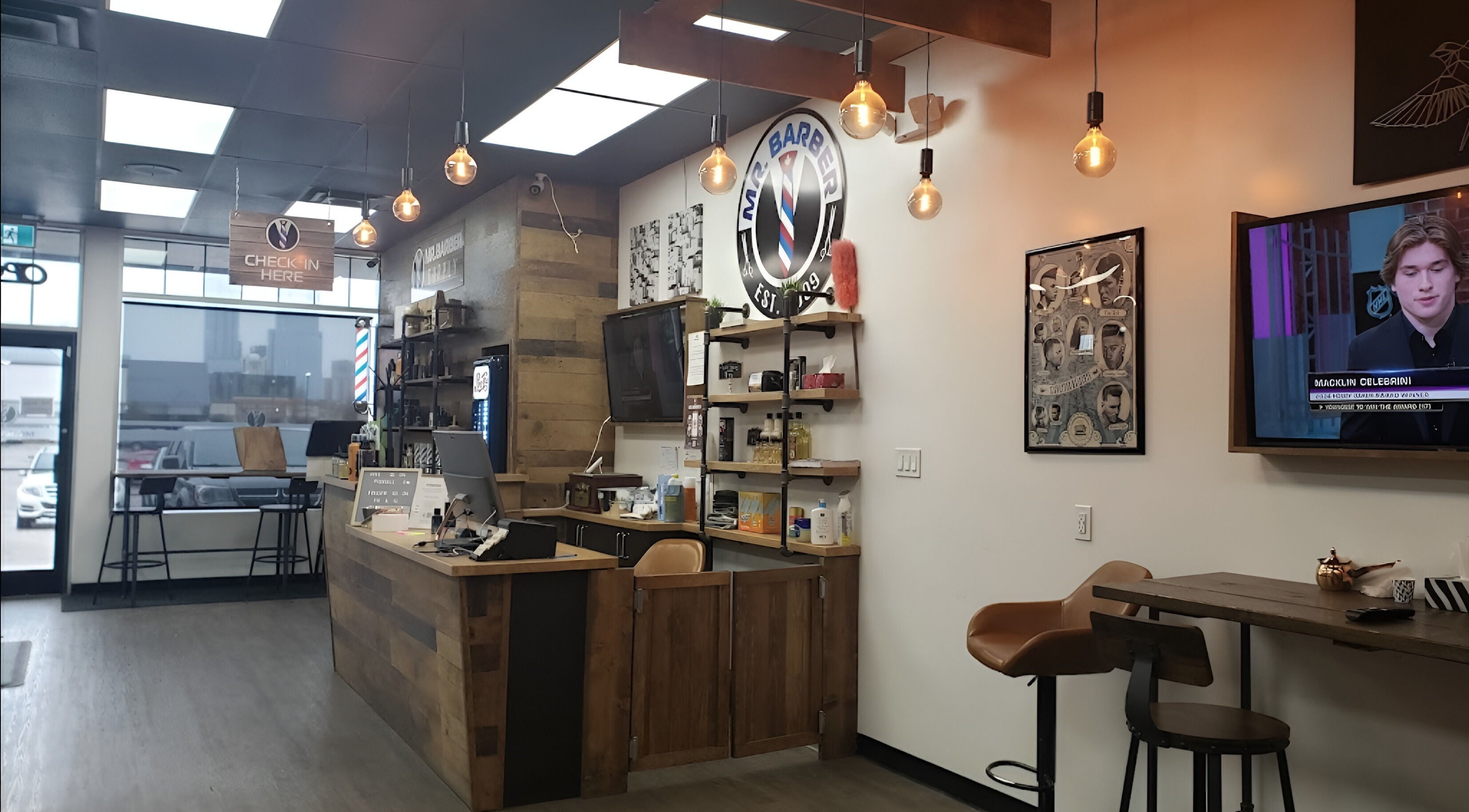 Interior of Mr. Barber Unity Square in Edmonton, Alberta, CA with modern decor and seating area.
