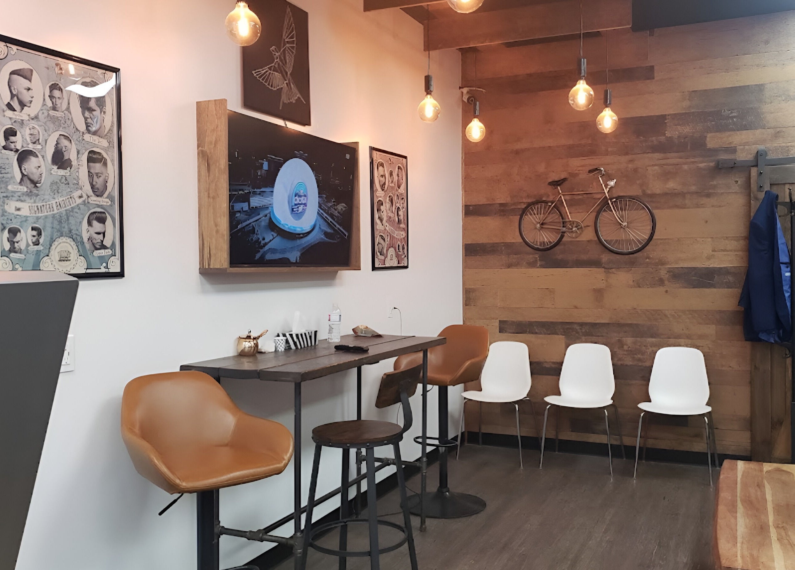 Stylish seating area at Mr. Barber Unity Square in Edmonton, Alberta, CA, featuring modern decor and warm lighting.