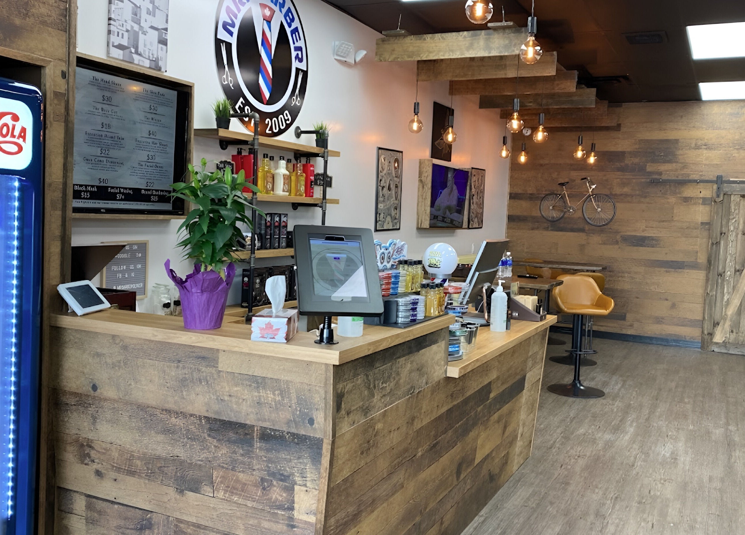 Cozy interior of Mr. Barber Unity Square, Edmonton, Alberta, CA with wooden decor and modern lighting.