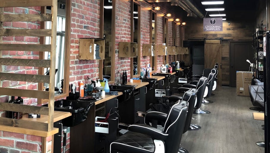 Sophisticated interior of Mr. Barber Fort Saskatchewan, Alberta, CA with modern barber chairs and styling stations.