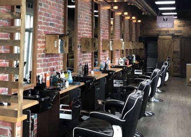 Sophisticated interior of Mr. Barber Fort Saskatchewan, Alberta, CA with modern barber chairs and styling stations.