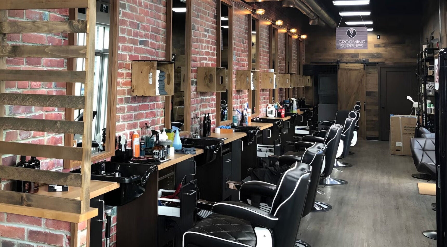 Sophisticated interior of Mr. Barber Fort Saskatchewan, Alberta, CA with modern barber chairs and styling stations.