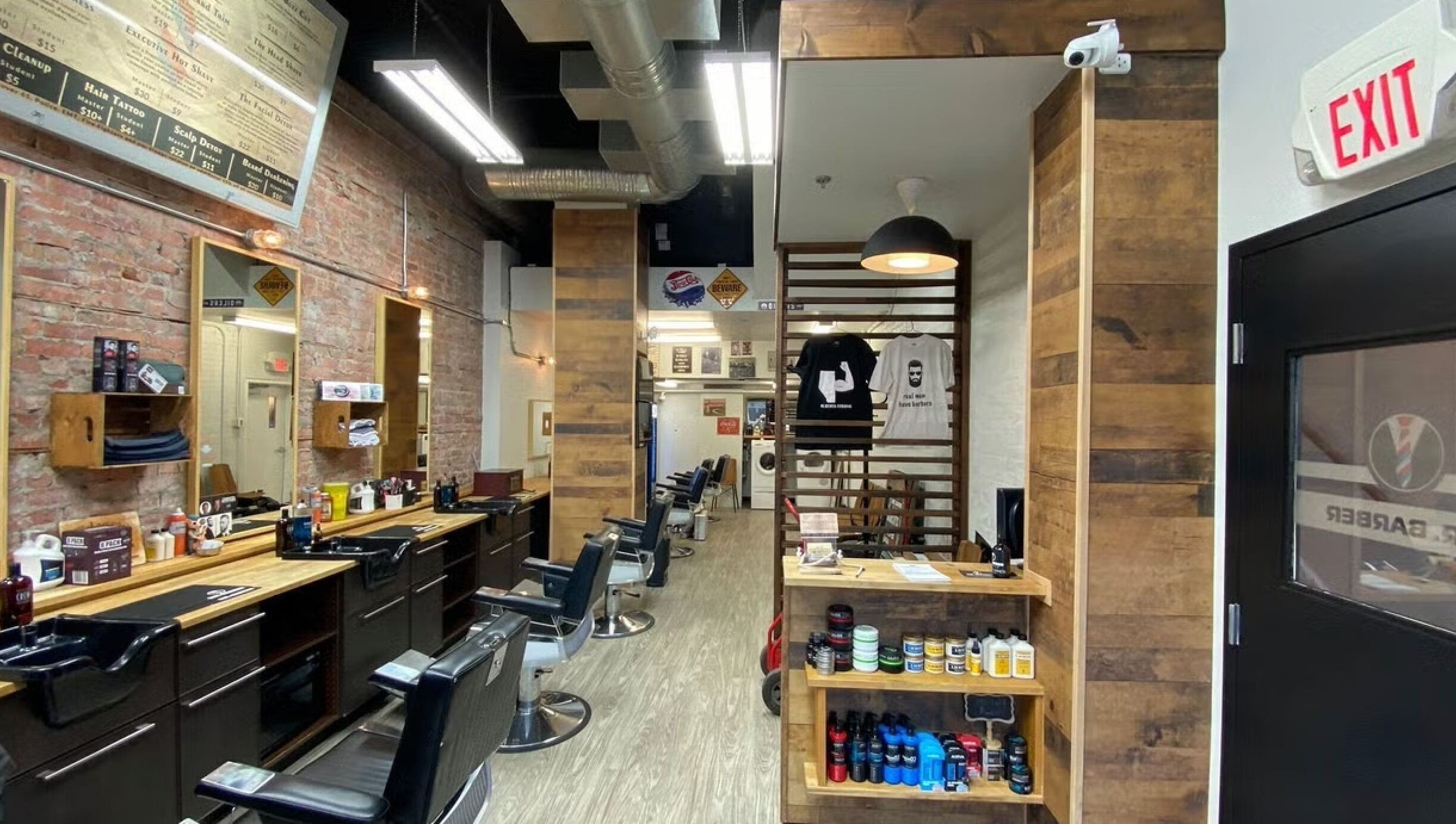 Modern interior of Mr. Barber Griesbach, Edmonton, Alberta, CA showcasing wooden decor and barber chairs.