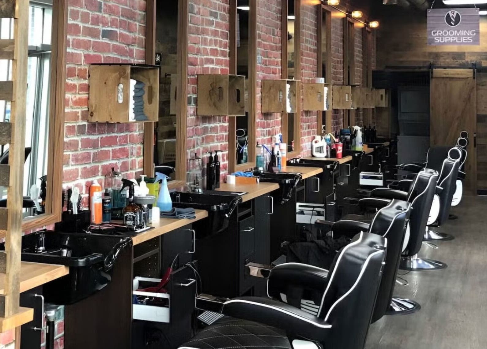 Modern interior of Mr. Barber Griesbach in Edmonton, Alberta, CA featuring sleek barber chairs and styling stations.