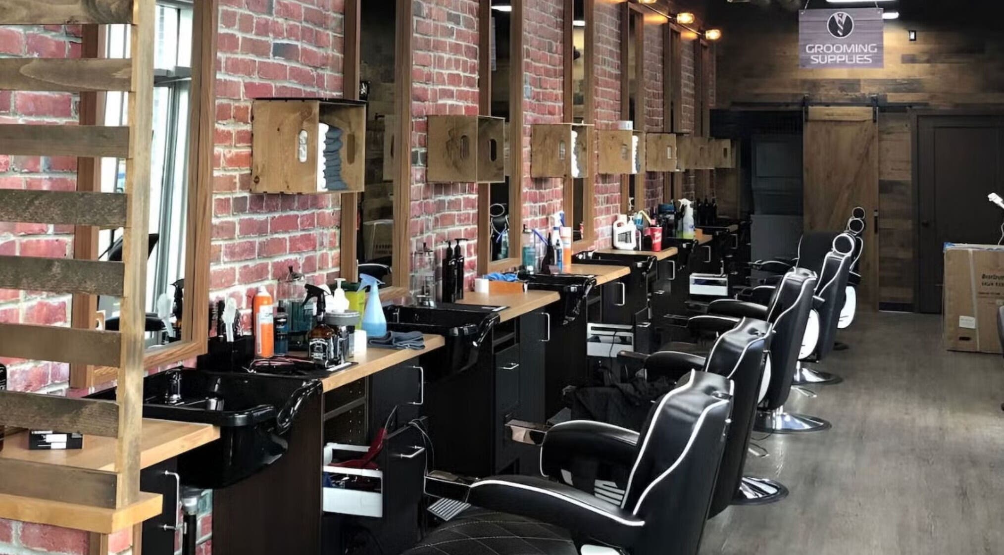 Modern interior of Mr. Barber Griesbach in Edmonton, Alberta, CA featuring sleek barber chairs and styling stations.