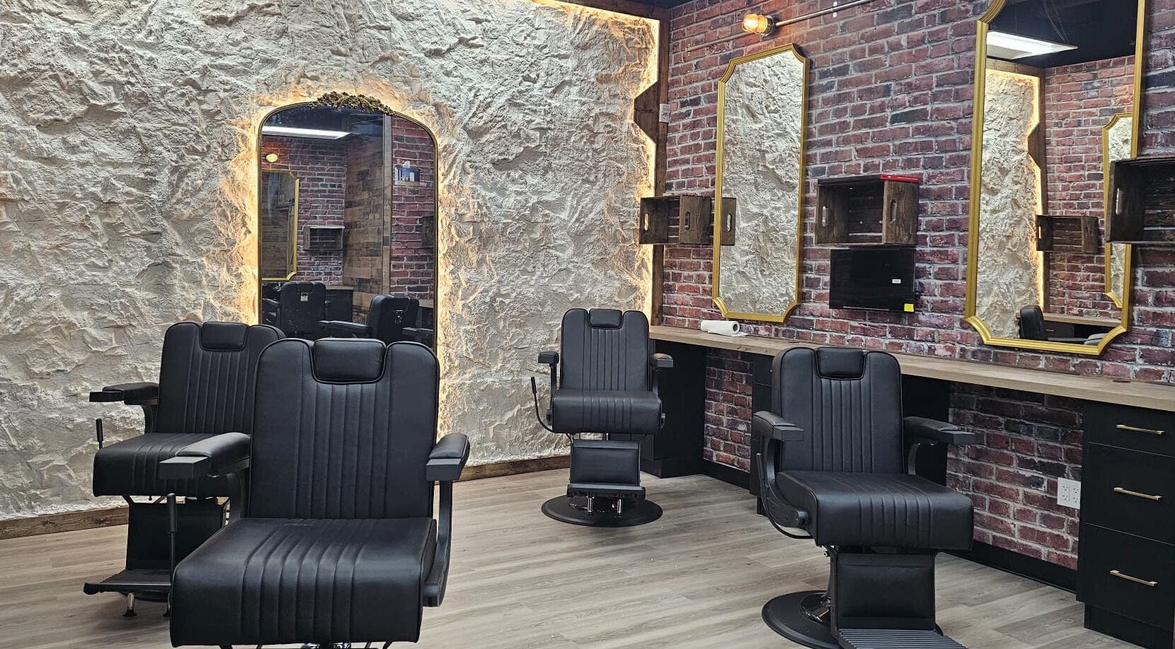 Interior of Mr. Barber Griesbach in Edmonton, Alberta, CA with black chairs and rustic decor.
