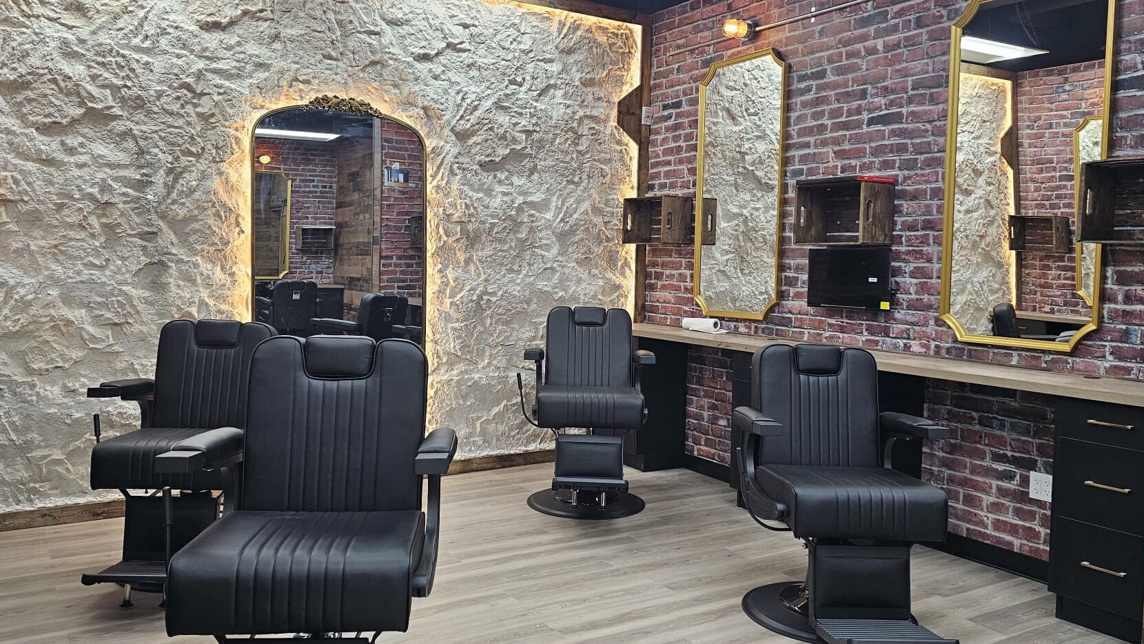 Interior of Mr. Barber Griesbach in Edmonton, Alberta, CA with black chairs and rustic decor.