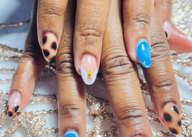 Stylish nail art with blue and animal print at Three Sisters Spa And Beauty Center, Long Bay West End, AI.
