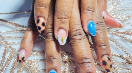 Stylish nail art with blue and animal print at Three Sisters Spa And Beauty Center, Long Bay West End, AI.