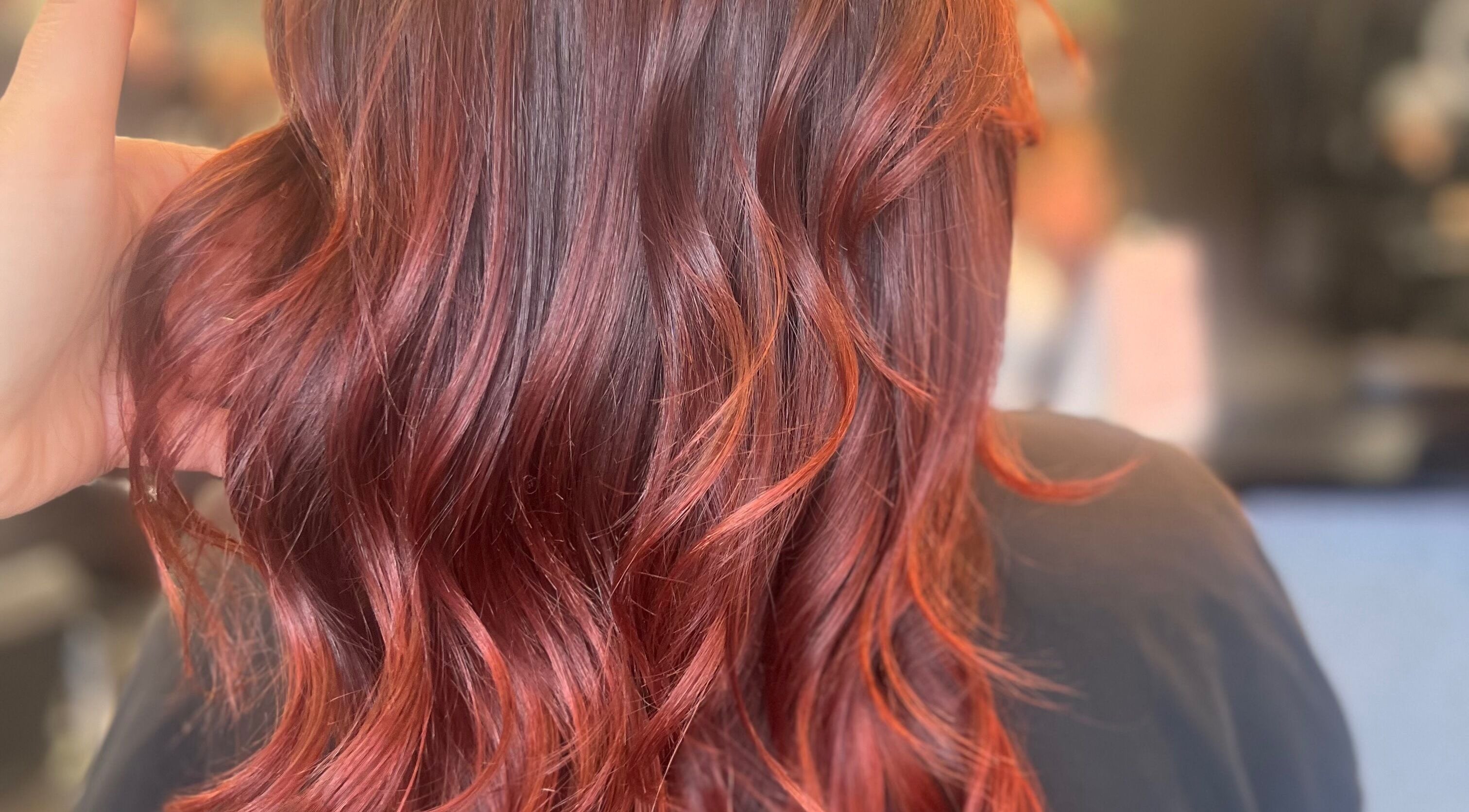 Vibrant auburn waves styled at Anna Kouro Hair, London, England, GB showcasing expert coloring.