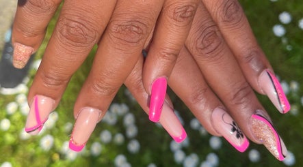 Bright nail art at Nailphoria Beauty in Leeds, England, GB, showcasing intricate pink and gold designs.