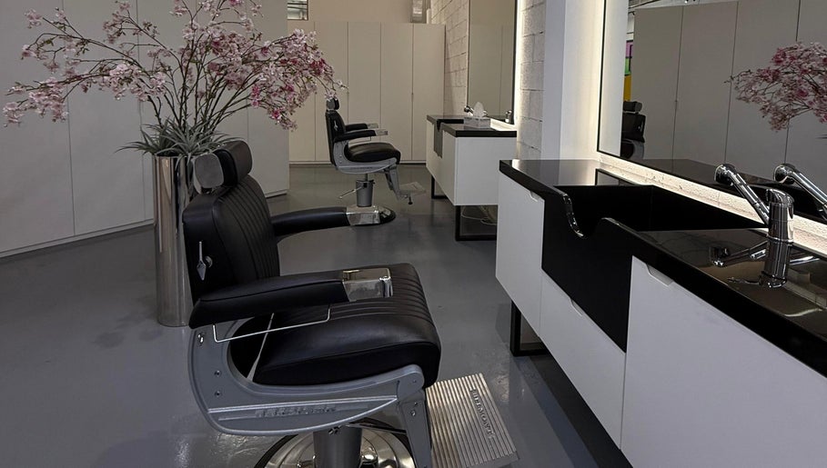 Sleek barber chair and sink at 8088 Barbershop - Avant Garde in Dubai, AE, showcasing a modern interior.