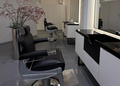 Sleek barber chair and sink at 8088 Barbershop - Avant Garde in Dubai, AE, showcasing a modern interior.