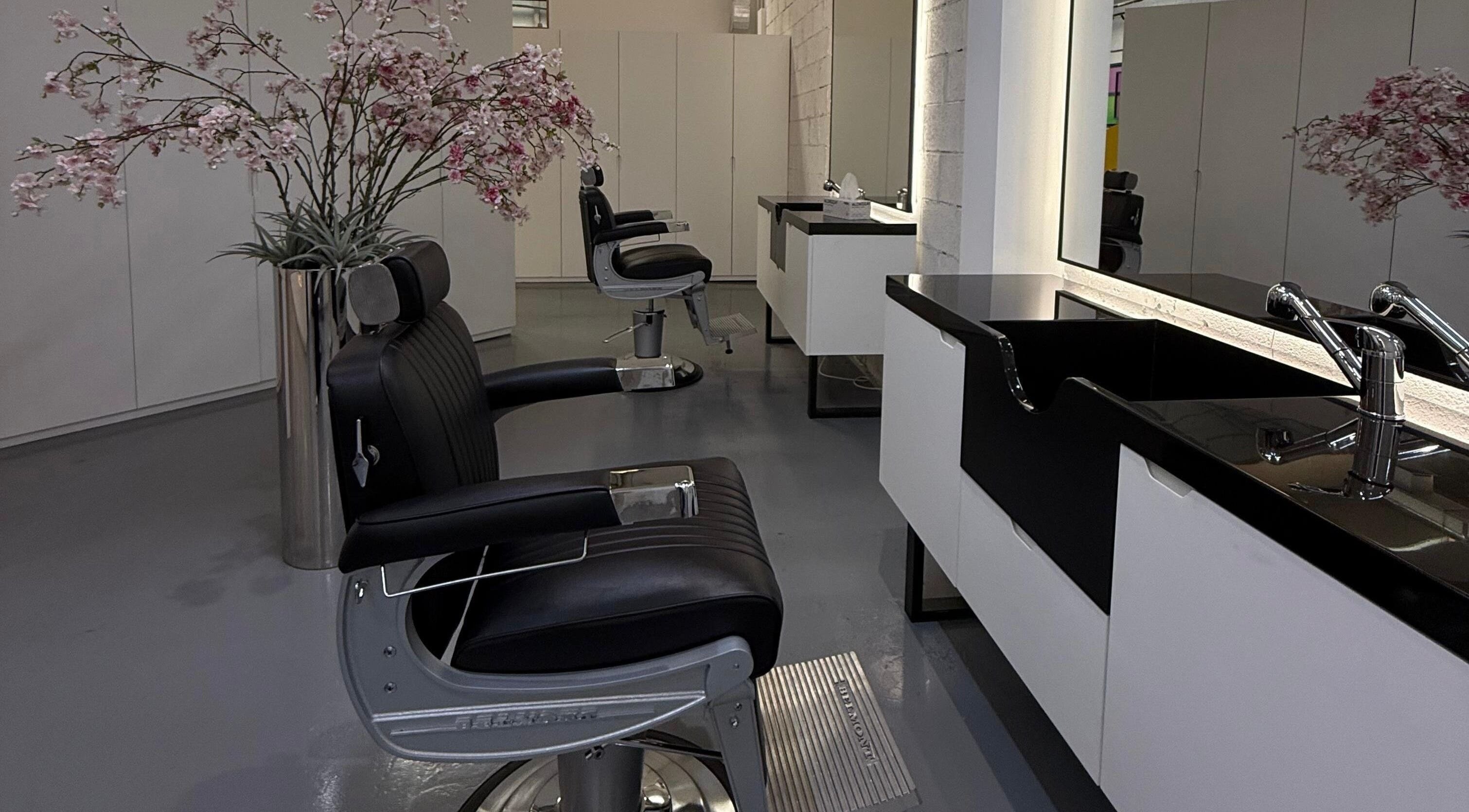 Sleek barber chair and sink at 8088 Barbershop - Avant Garde in Dubai, AE, showcasing a modern interior.