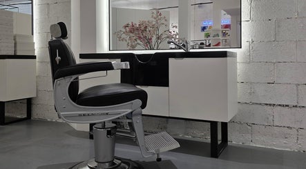 Modern barber chair in 8088 Barbershop - Avant Garde, Dubai, AE, with sleek black and silver design.