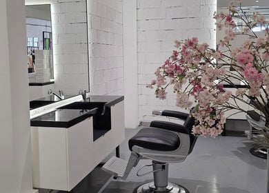 Elegant salon chair and sink at 8088 Barbershop - Avant Garde in Dubai, AE with cherry blossoms.