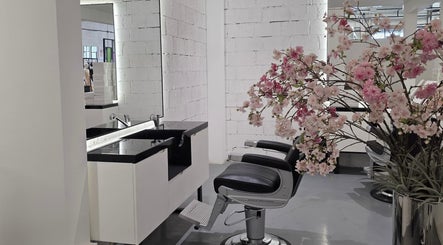 Elegant salon chair and sink at 8088 Barbershop - Avant Garde in Dubai, AE with cherry blossoms.