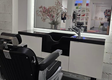 Modern barber station at 8088 Barbershop - Avant Garde, Dubai, AE. Sleek chair and elegant flower decor.