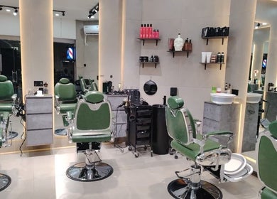 Modern salon interior at 8088 Express - Al Jaffiliya, Dubai, AE with green chairs and mirrored walls.