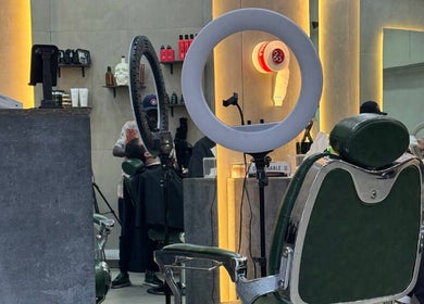 Modern barber chair and ring light at 8088 Express - Al Jaffiliya, Dubai, AE, offering premium grooming services.