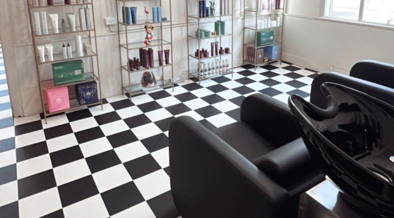 Interior of Larnah Puttock Hairdressing in Mudgee, New South Wales, AU, showcasing stylish salon products and chairs.