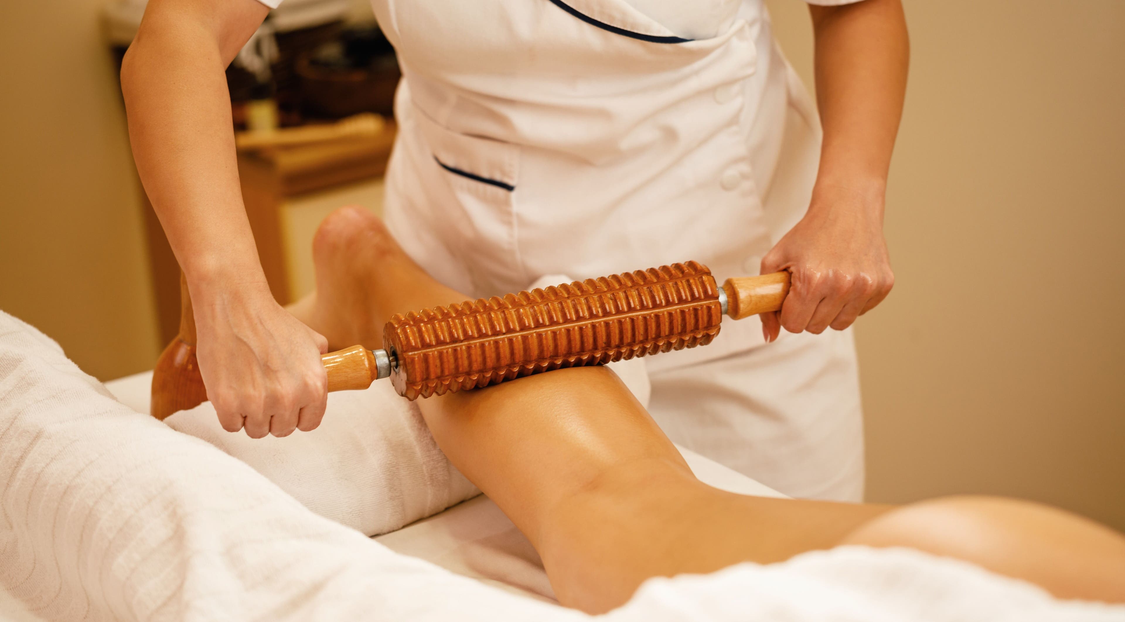 Thérapeute utilisant un rouleau en bois au W CARE CENTER à Chevry-cossigny, Île-de-france, FR.