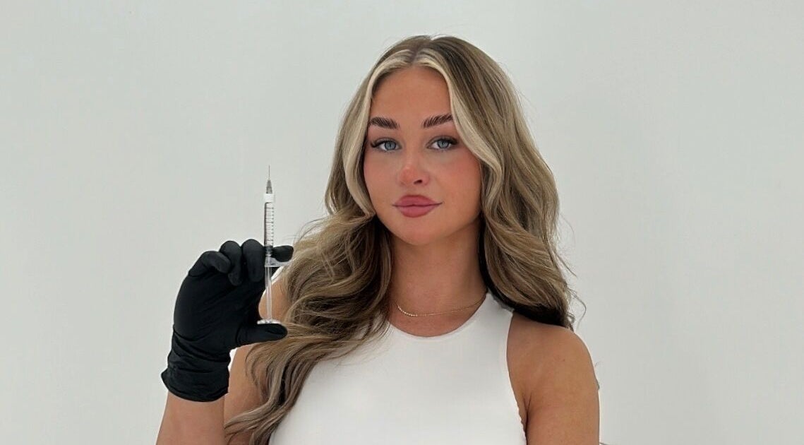 Cosmetic specialist at EBL Aesthetics Clinic holding syringe, Poulton-le-Fylde, England, GB.