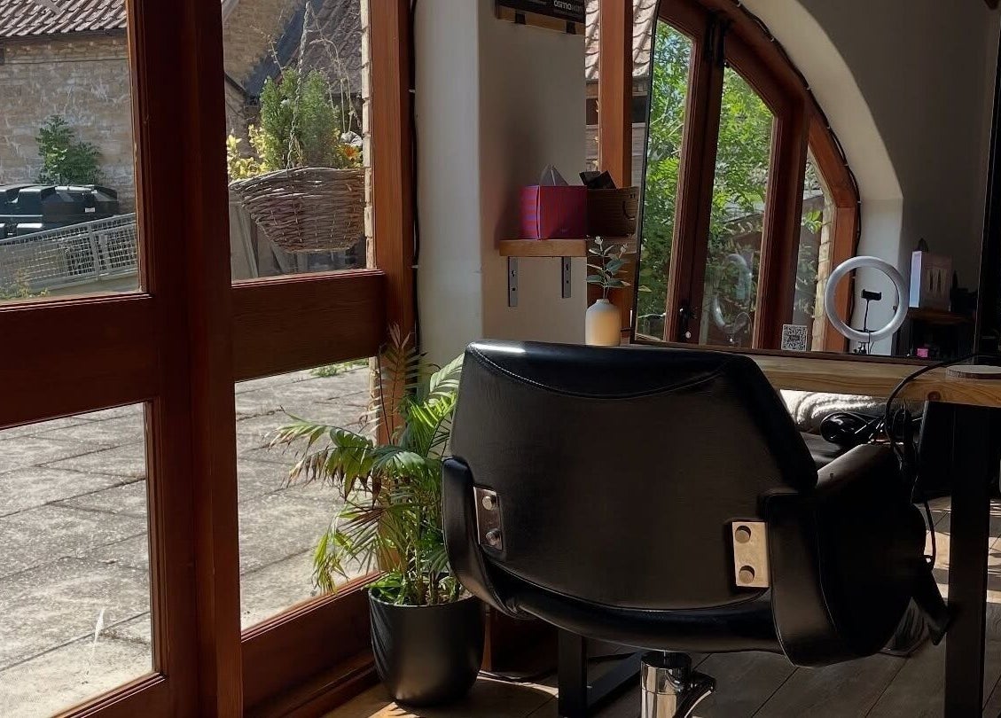 Inviting sunny salon space at Bavaro, Aldwincle, England, GB, with modern decor and large windows.