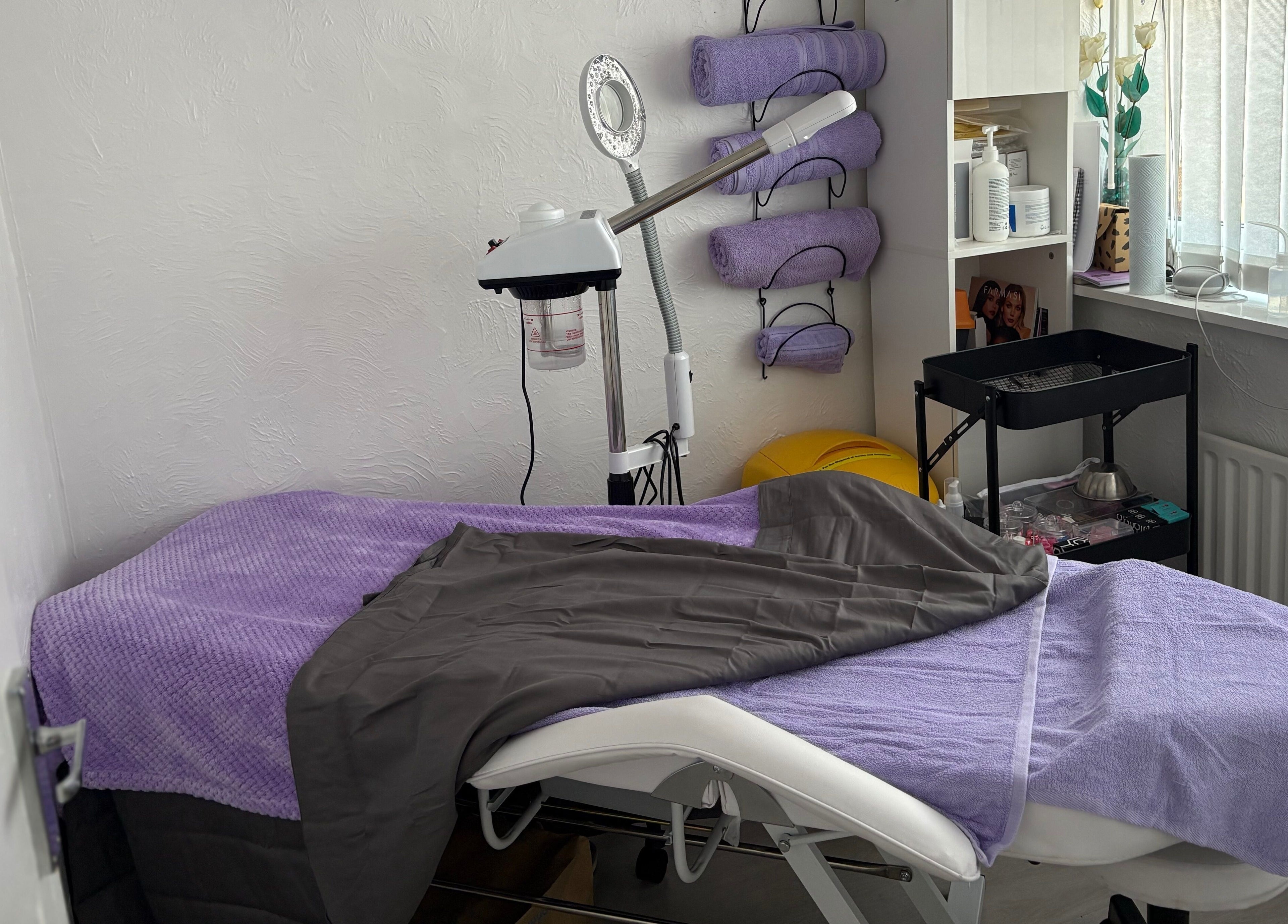 Cozy treatment room at Timeless Beauty by Mel, Gravesend, England, GB with relaxing purple decor.