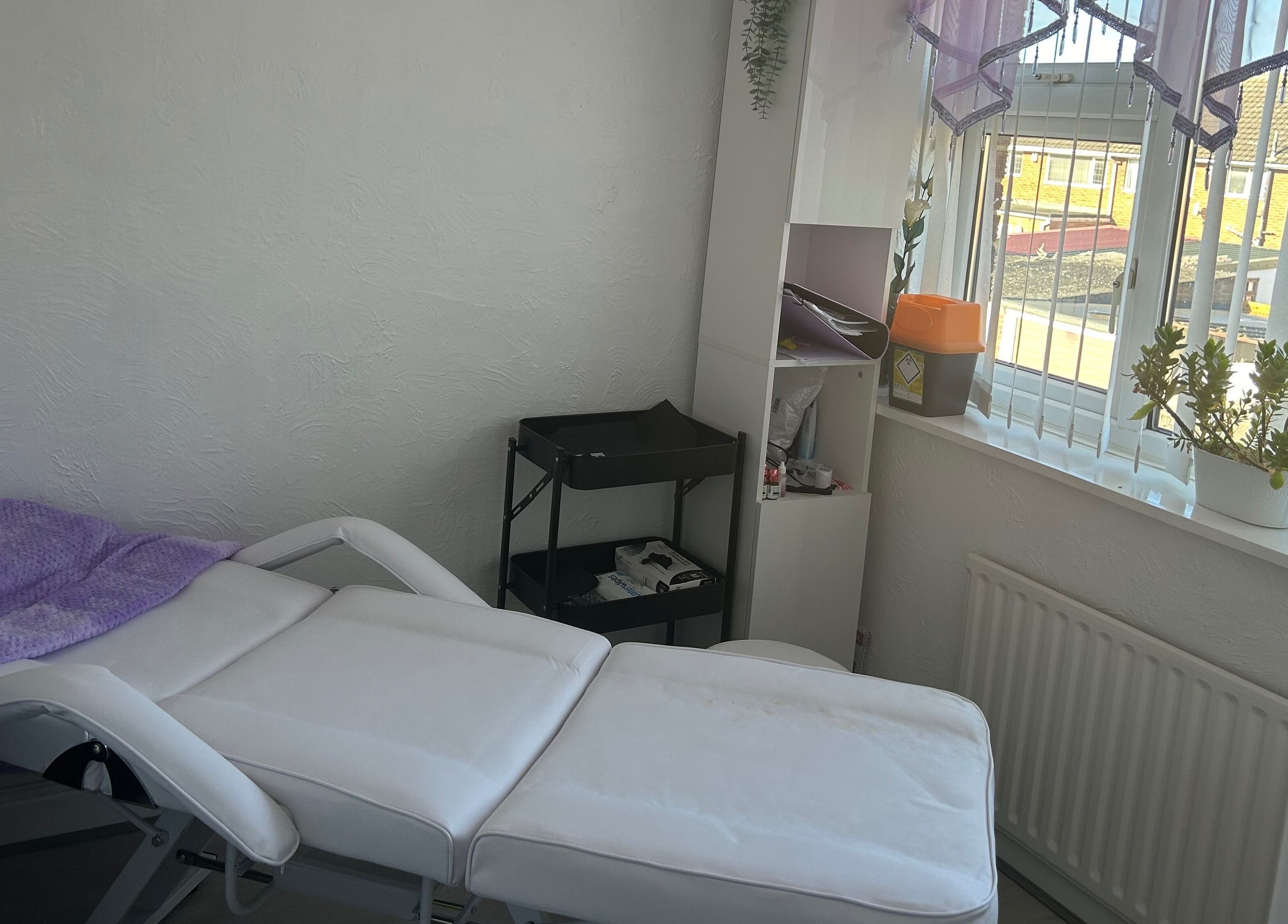 Relaxing treatment room at Timeless Beauty by Mel, Gravesend, England, GB with a cozy massage bed and soft lighting.
