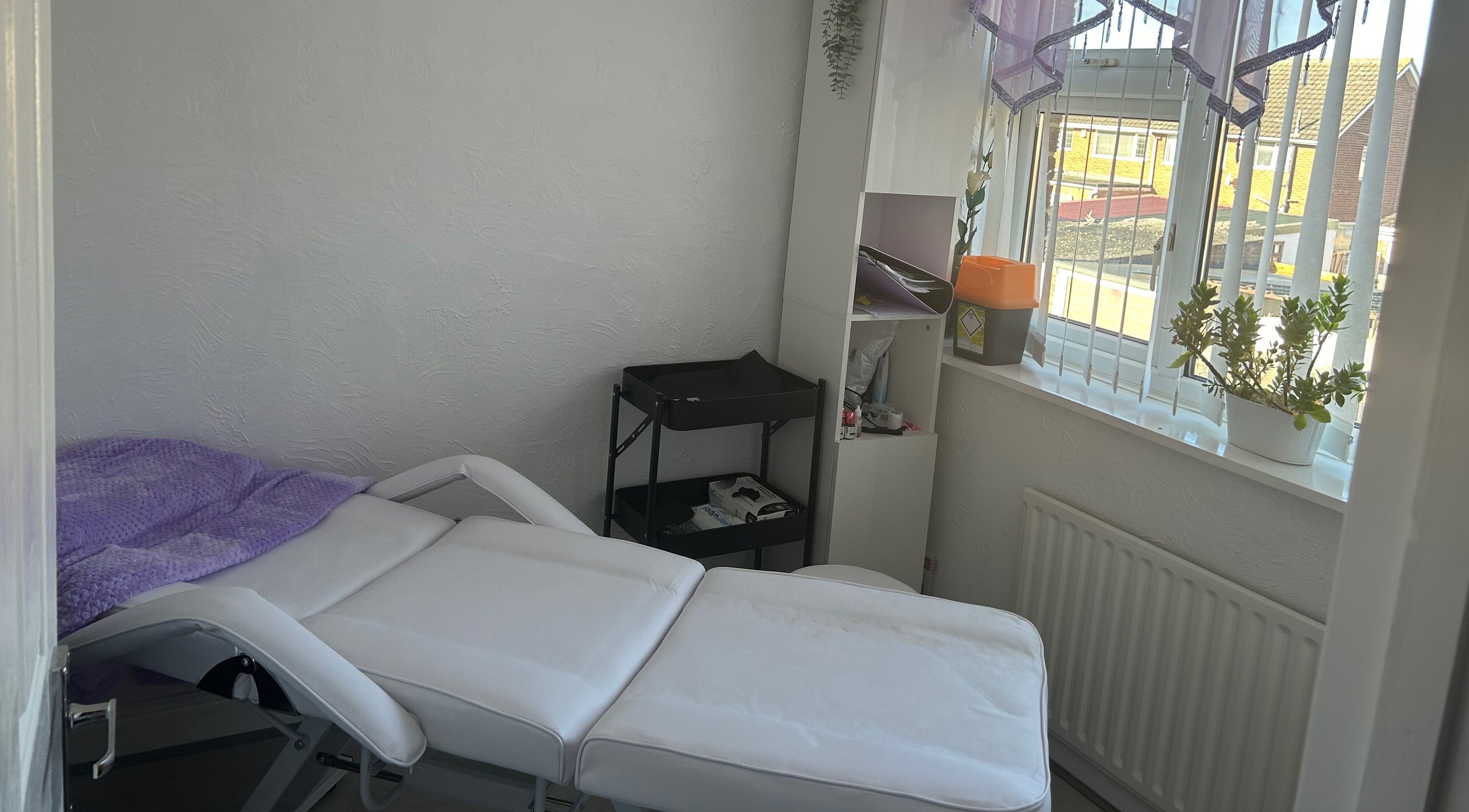 Relaxing treatment room at Timeless Beauty by Mel, Gravesend, England, GB with a cozy massage bed and soft lighting.