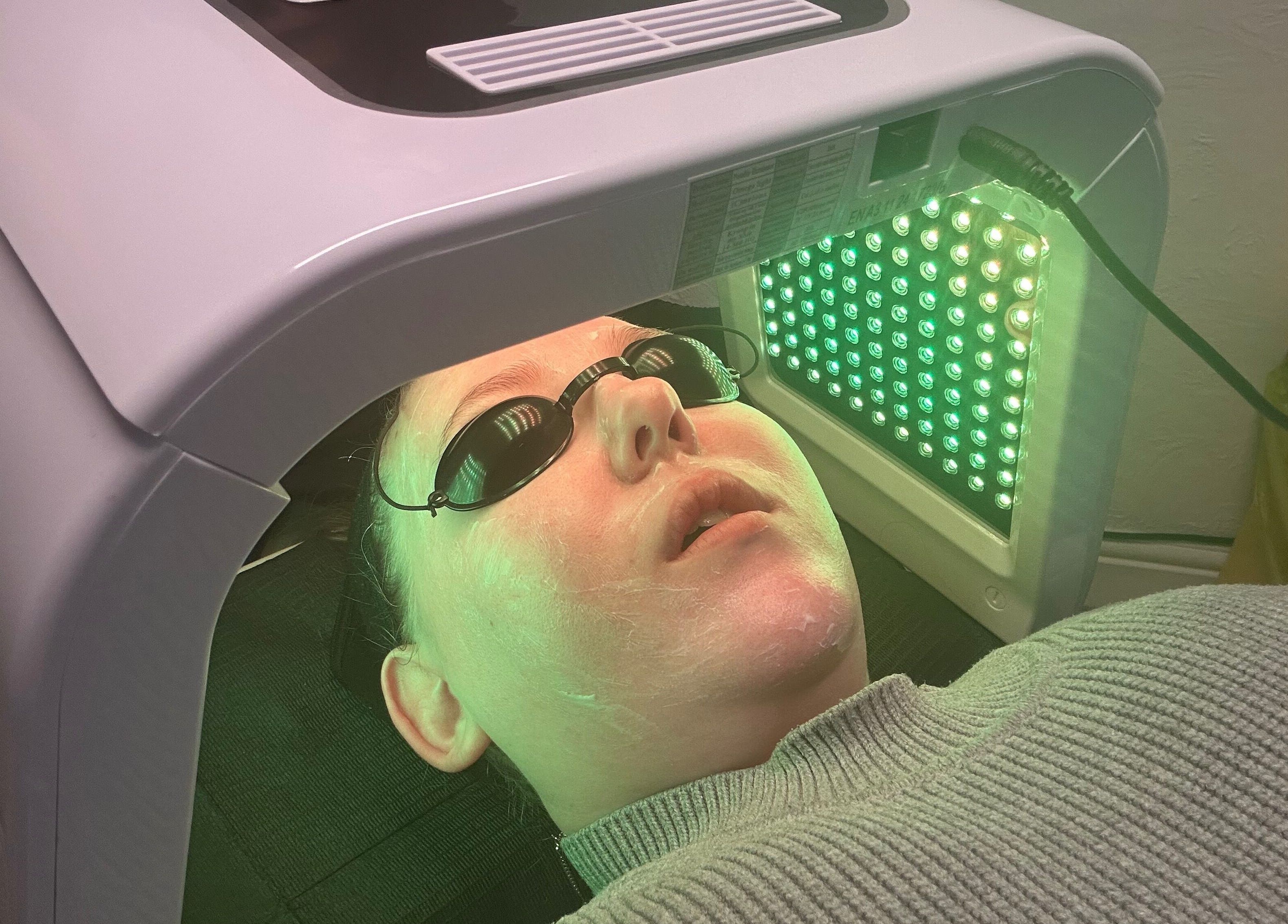 Client enjoying LED facial at Timeless Beauty by Mel, Gravesend, England, GB, under soothing green light.