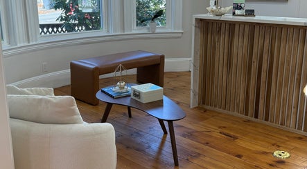 Cozy seating at Sandra Faria Beauty, Hudson, Massachusetts, with natural light and elegant decor.