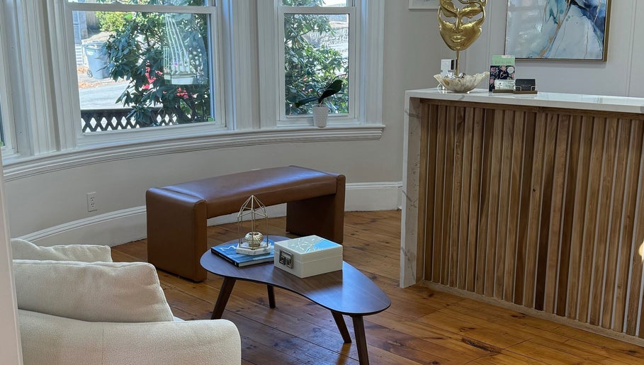 Elegant reception area at Sandra Faria Beauty, Hudson, Massachusetts, US with cozy seating and decor.