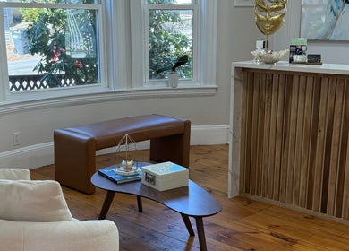 Elegant reception area at Sandra Faria Beauty, Hudson, Massachusetts, US with cozy seating and decor.