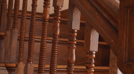 Elegant wooden staircase at Sandra Faria Beauty in Hudson, Massachusetts, US, showcasing craftsmanship.