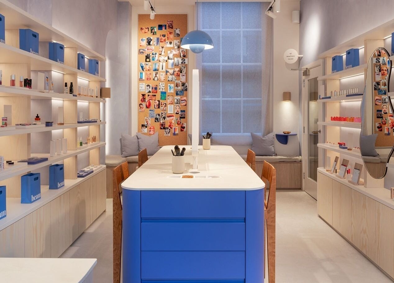 Modern interior of Beam in London, England, GB featuring sleek shelves and vibrant beauty displays.