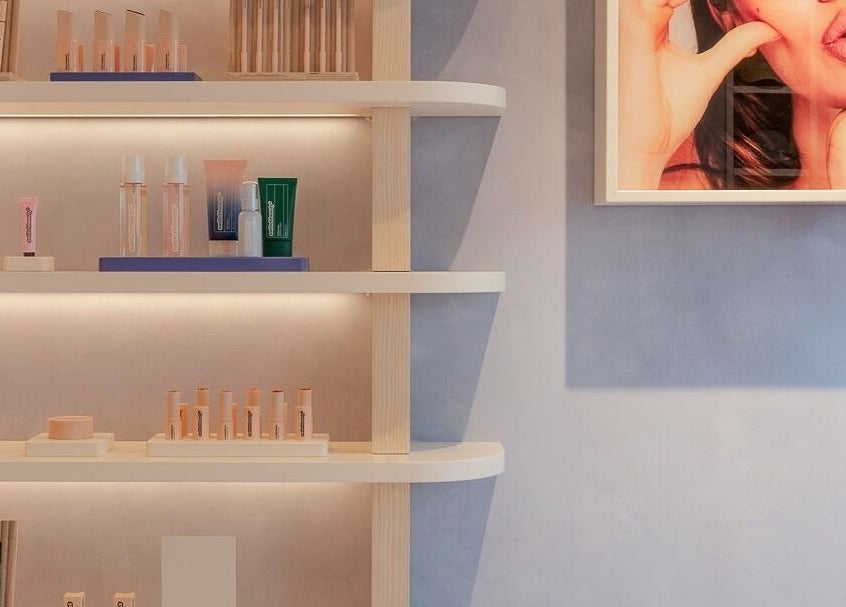 Modern beauty products on lit shelves at Beam venue, London, England, GB.