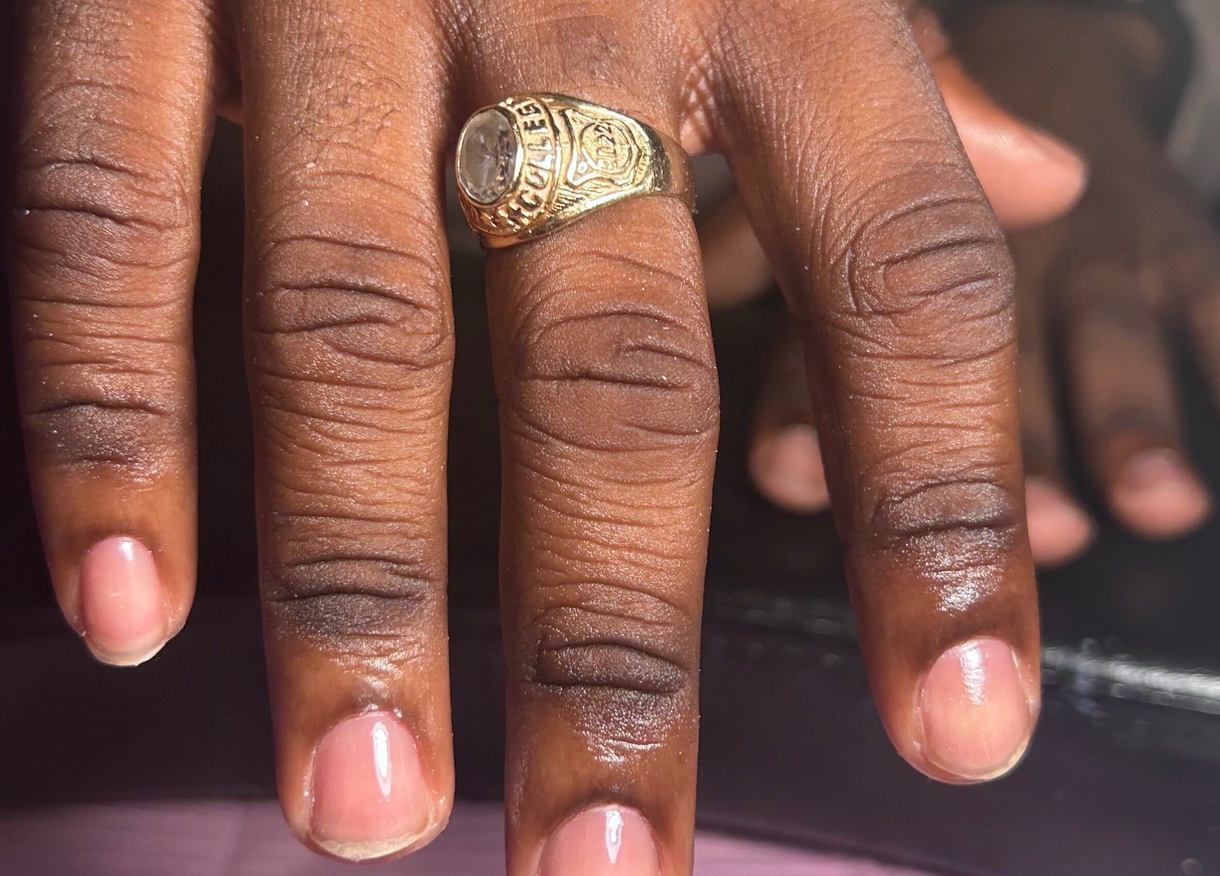 Close-up of a hand with a gold ring at Nailzbyshaeimani, Kingston, St. Andrew Parish, JM.